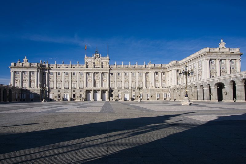 Royal Palace of Madrid facade under a blue sky