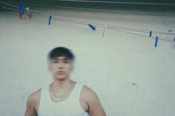 Man in a White Tank Top Near Clothespins