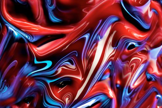 Dynamic fluid art with bold red and blue swirls creating a vibrant abstract texture.
