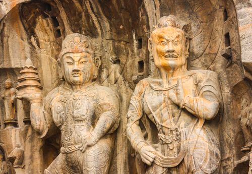 Free Detailed view of ancient Buddhist sculptures at the Longmen Grottoes in Luoyang, China. Stock Photo