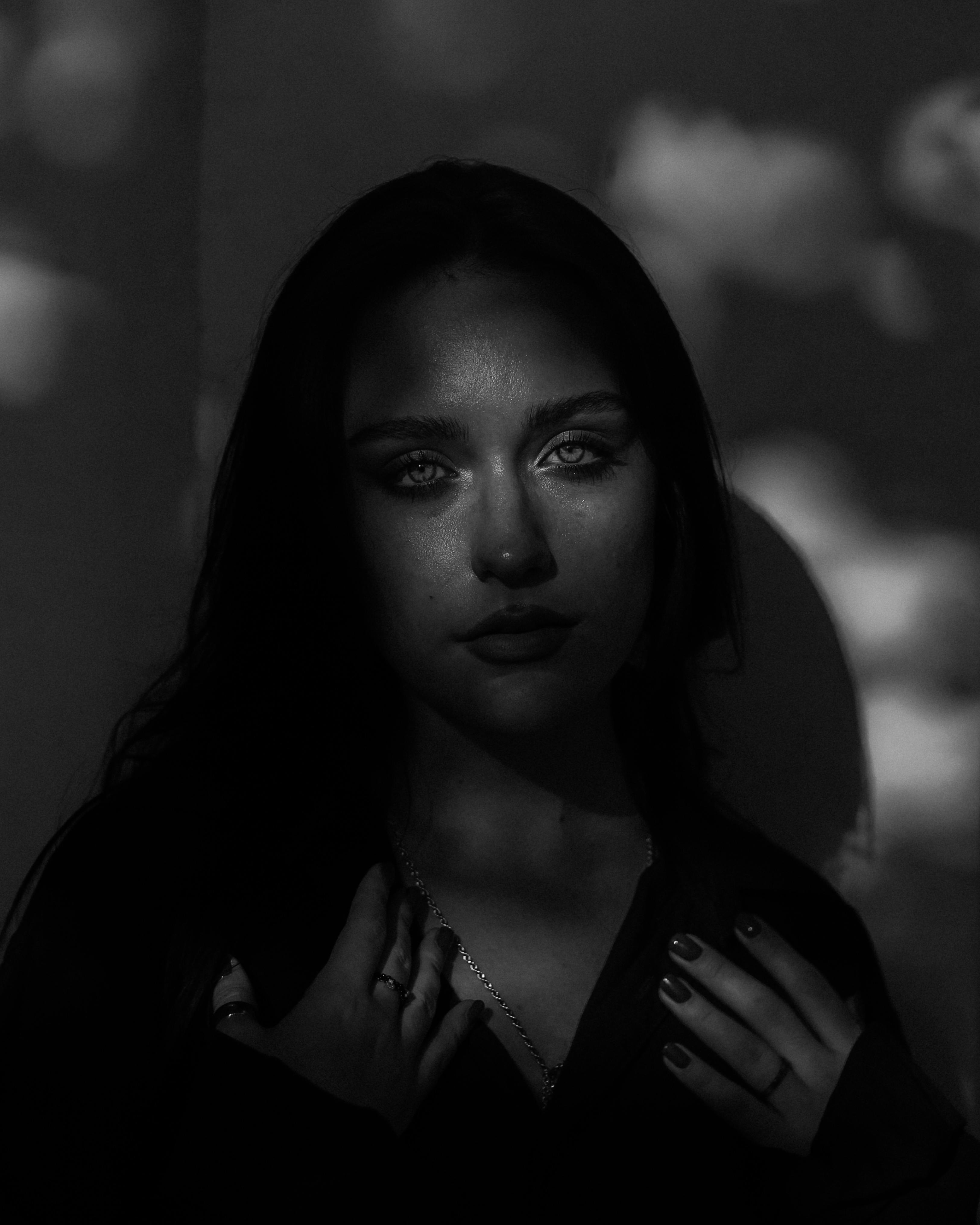 Captivating black and white portrait of a woman in dramatic lighting, Moscow.
