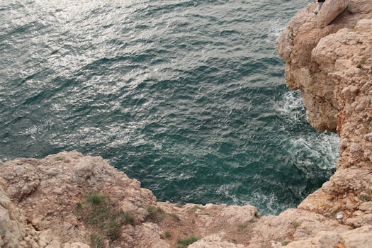 A stunning view of the sea waves crashing against rocky cliffs in Sevastopol.