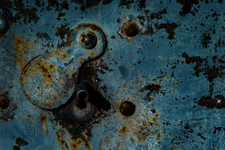 A Rusty Metal Surface With Paint Peeling Off