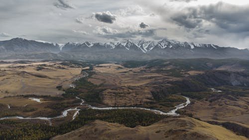 Snow Covered Mountains View from Brown Landscape