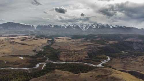 Free Spectacular aerial view of snow-capped Altai mountains and winding river in Russia. Stock Photo