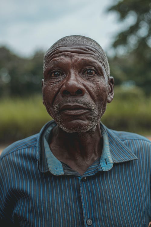 An Elderly Man in Striped Polo Shirt