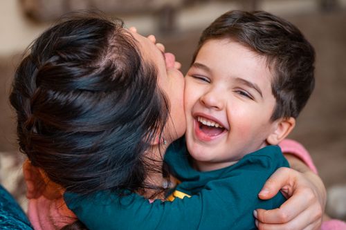 Free Close-up of a joyful mother and child embracing indoors, filled with warmth and happiness. Stock Photo