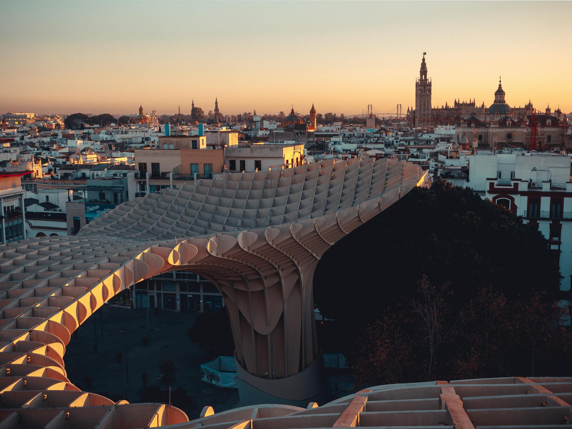 Aerial view of Metropol Parasol in Seville during sunset, capturing urban architecture.