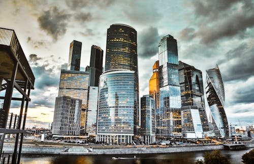 A Low Angle Shot of City Buildings Under the Cloudy Sky