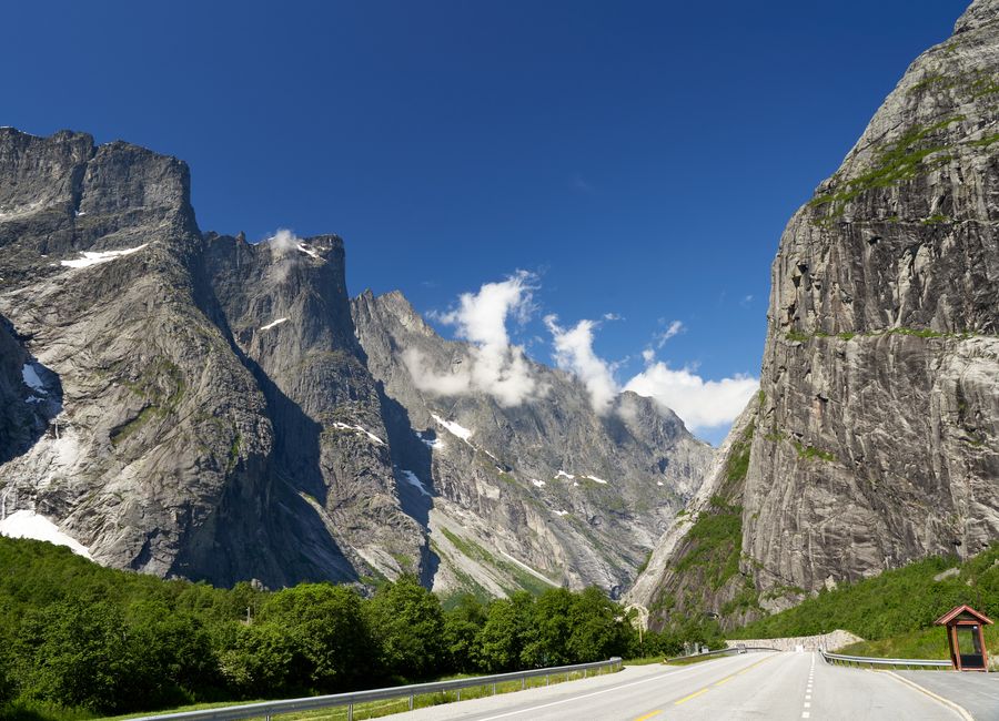 Breathtaking view of the mountains in Verma, Norway, with clear skies and a winding road.