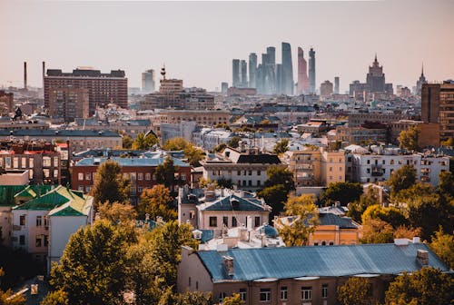 Free Aerial View of City Buildings and Green Trees Stock Photo