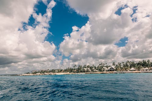 Blue Sea Under Blue and White Cloudy Sky