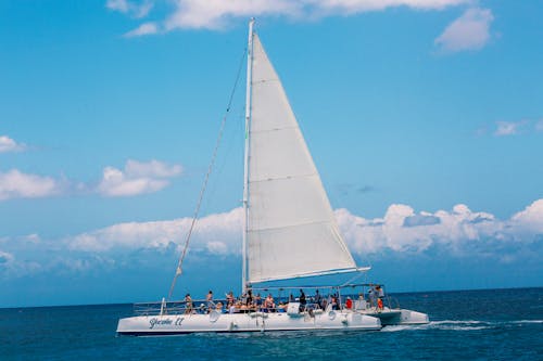 Free White Sail Boat on Sea Under Blue Sky Stock Photo