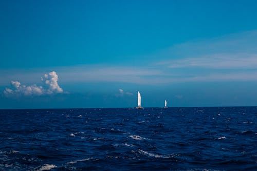 Free A Boat Sailing on the Sea Under the Blue Sky Stock Photo