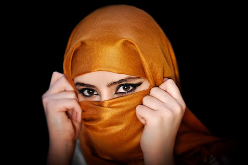 A Woman in Brown Hijab Looking at the Camera