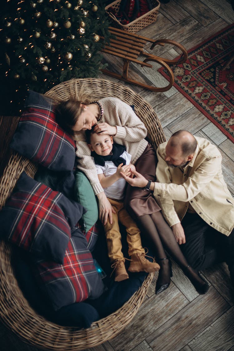 Family Sitting On Wicker Couch Seen From Above