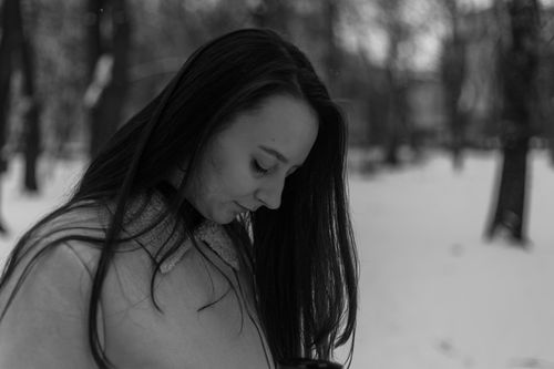 Free Black and white portrait of a woman outdoors in a snowy park in Vinnytsia, Ukraine. Stock Photo
