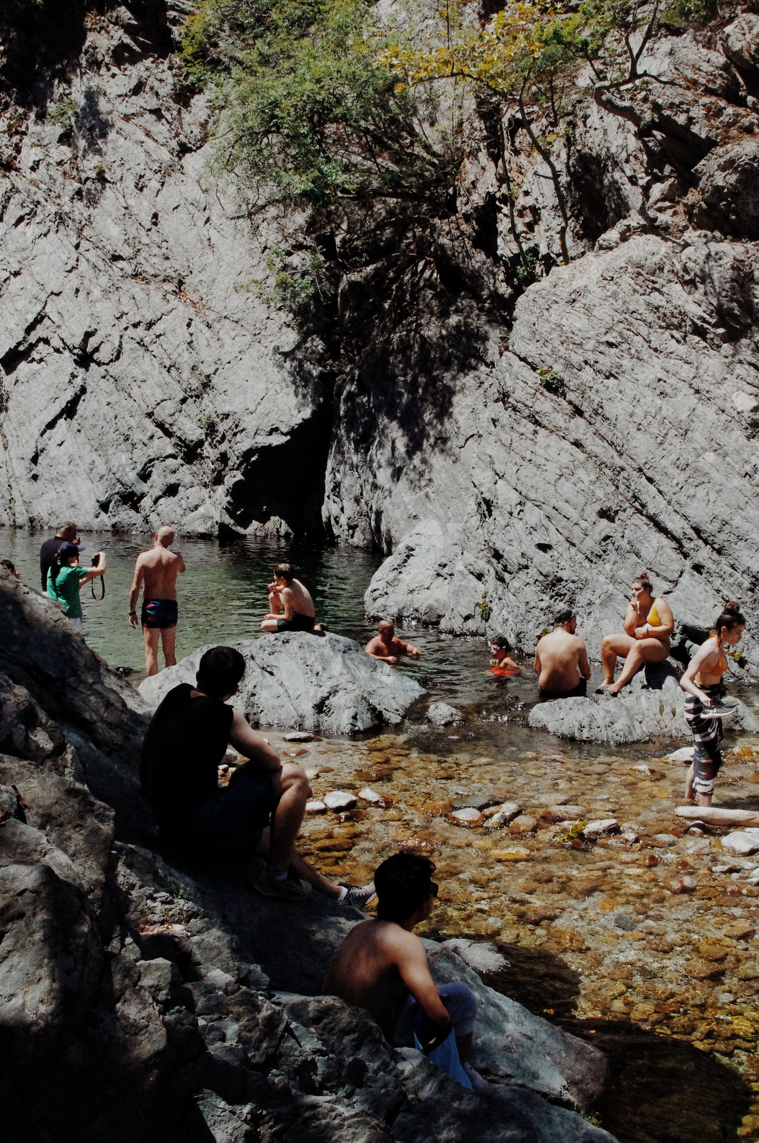 Swimmers at natural rock pools on Samothraki