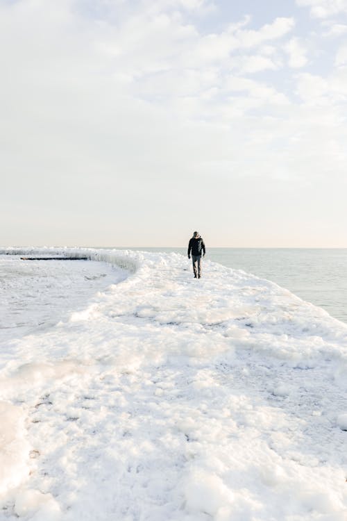 Man Walking on Snow on Lakeside Near Chicago, USA