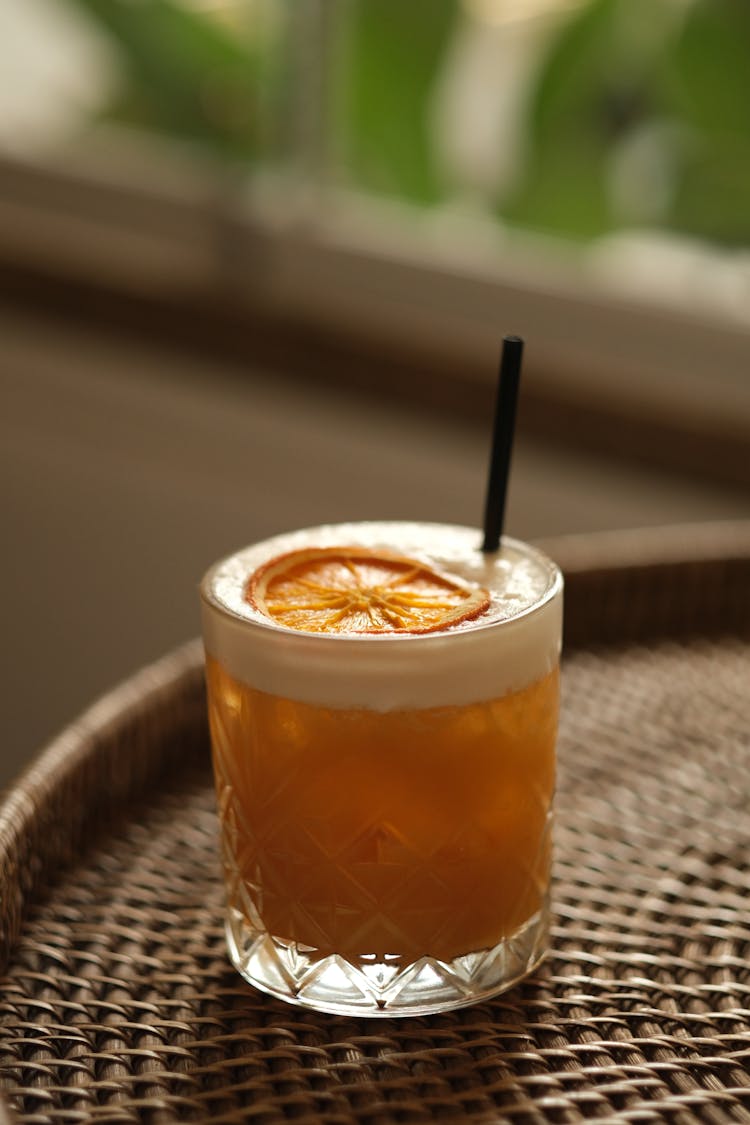 Clear Drinking Glass With Orange Liquid