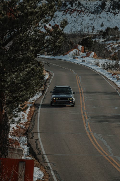 A BMW E30 Driving Down a Highway