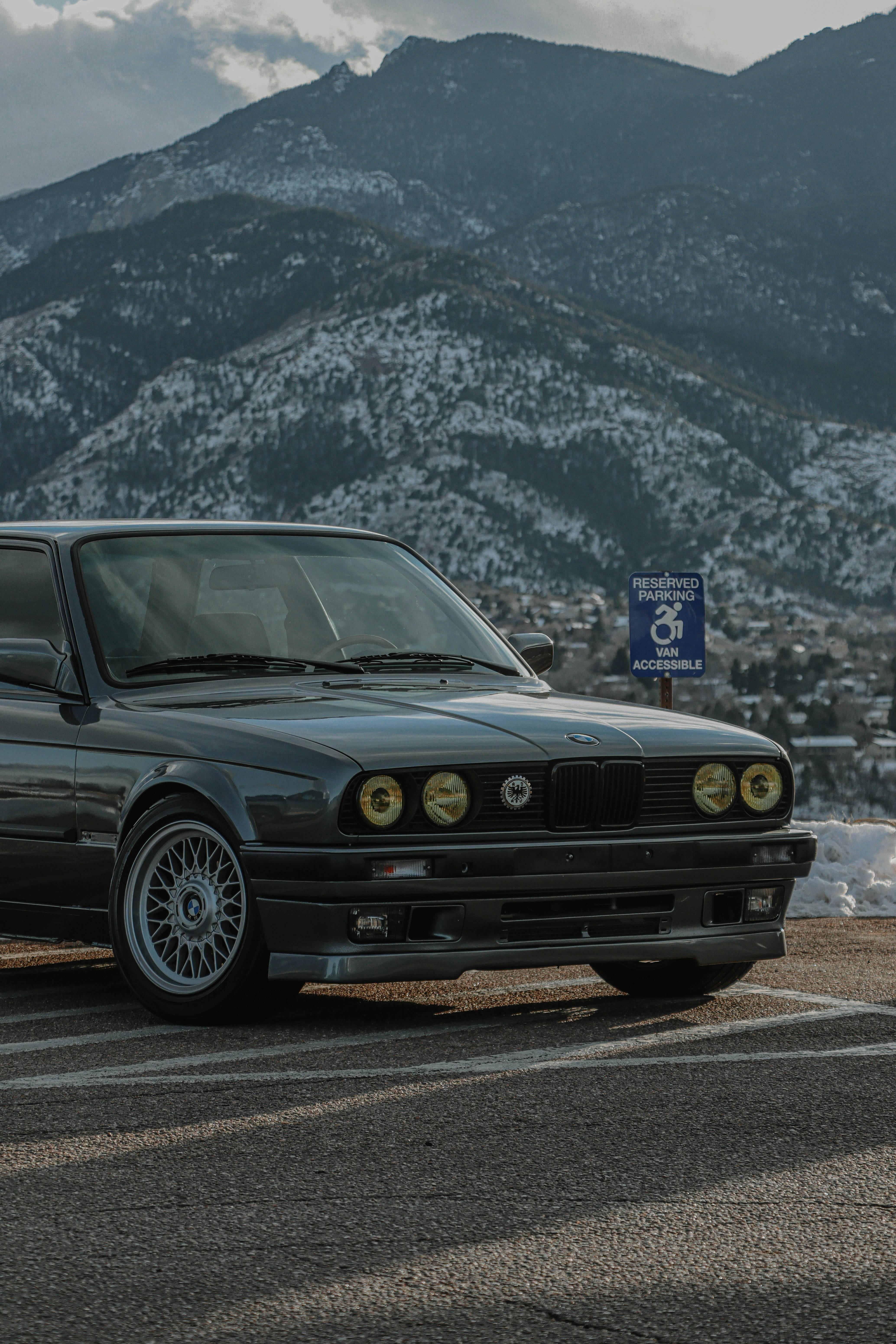 a car parked on the street near the mountain