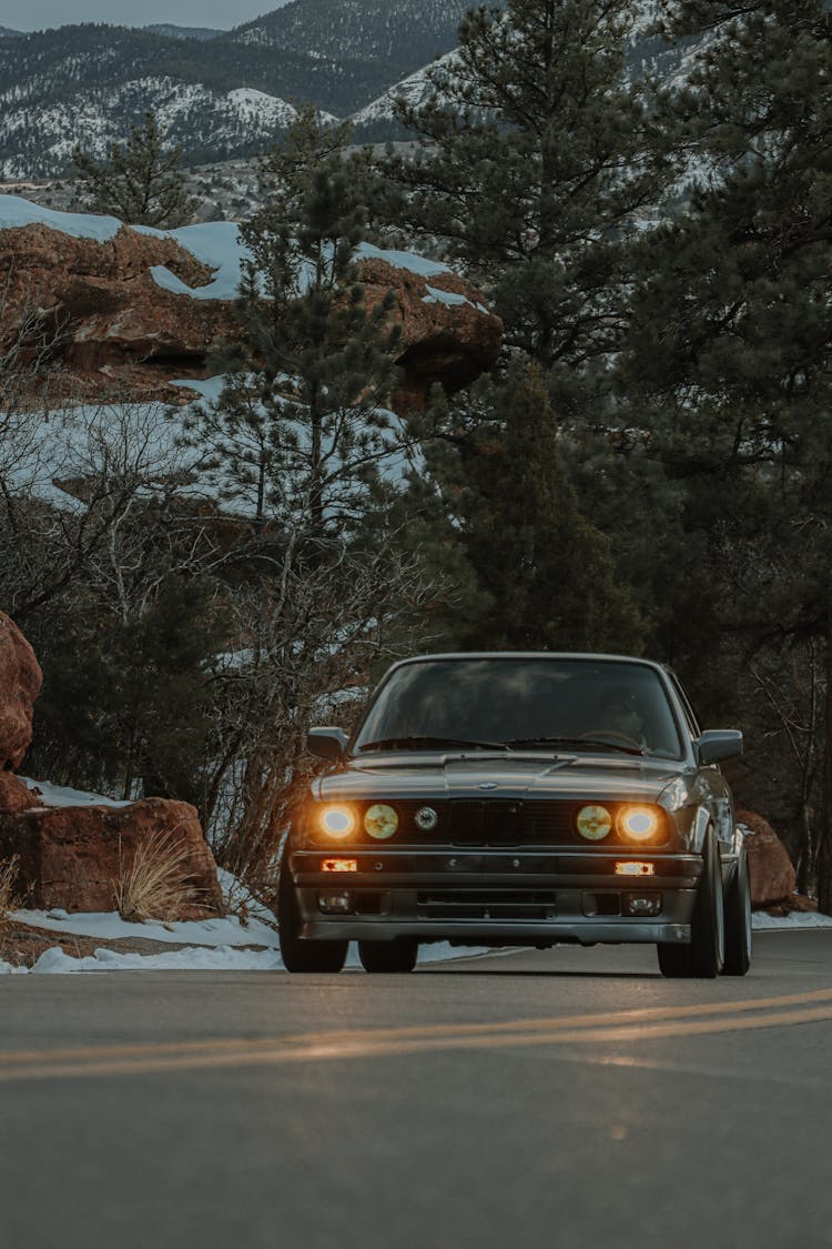 Person Driving A Black Car Near The Mountain