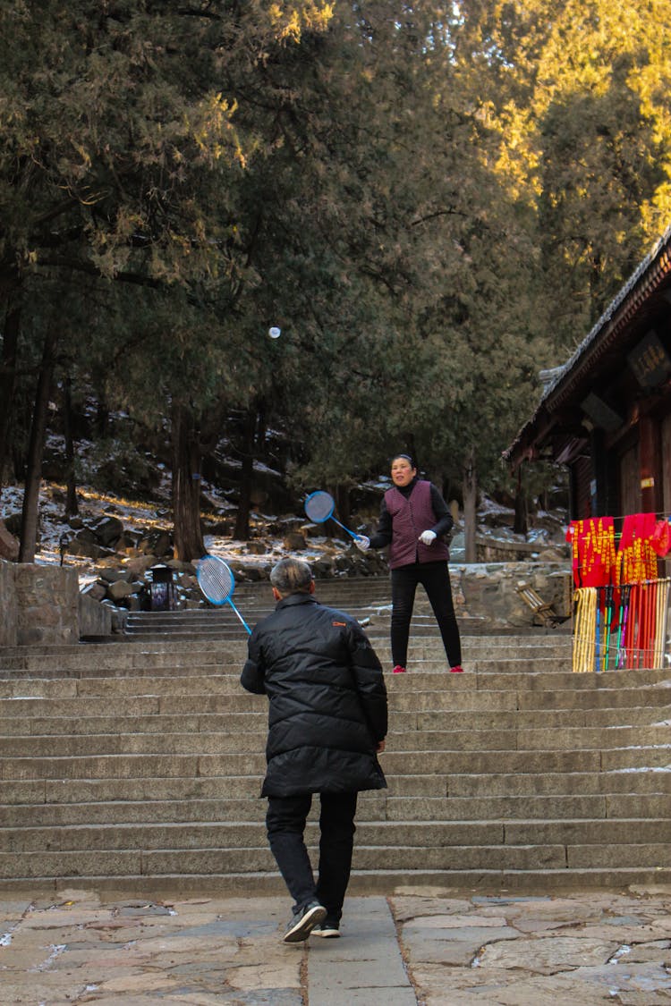 Two People Playing Badminton