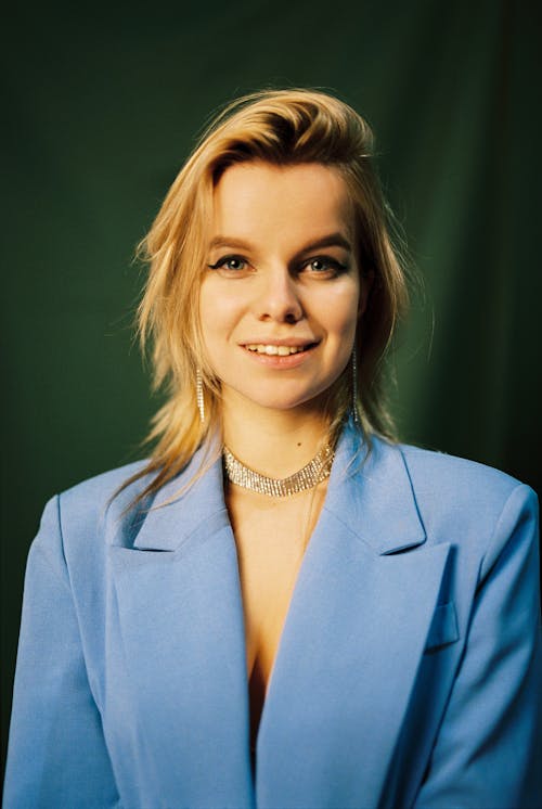 Smiling Blond Woman in Blue Jacket