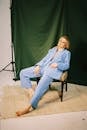 Barefoot Woman in Blue Suit Sitting Casually in Chair
