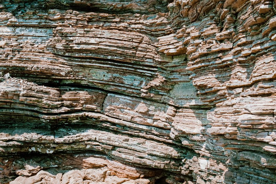 Close-up of stratified rock formation showcasing natural textures and layers.