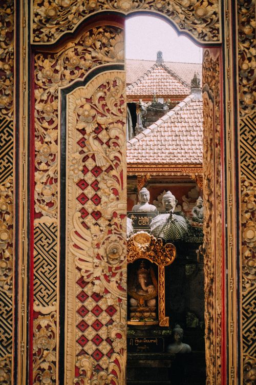 Free A beautifully carved doorway in a Balinese temple showcasing traditional art and architecture. Stock Photo