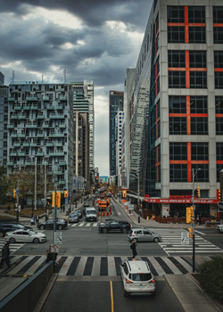 An urban view of a busy intersection amidst modern high-rises in Toronto, Canada.