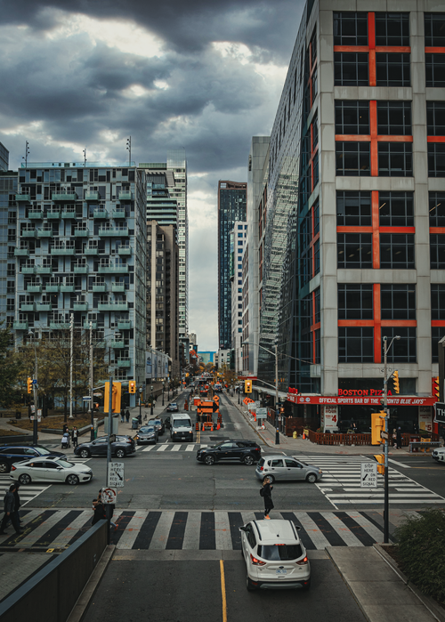 Free An urban view of a busy intersection amidst modern high-rises in Toronto, Canada. Stock Photo