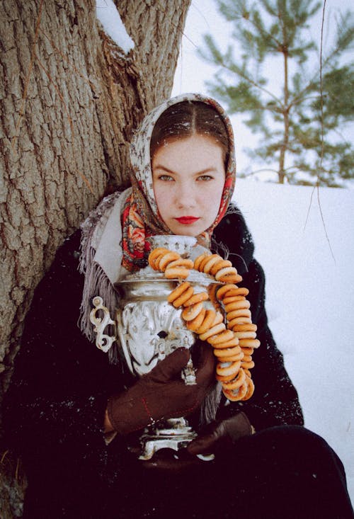 Woman with a Headscarf Holding a Samovar