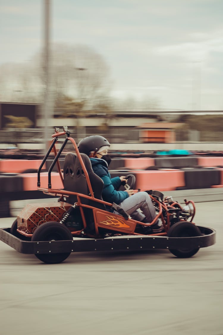 Kid Driving Go-Kart On Speedway