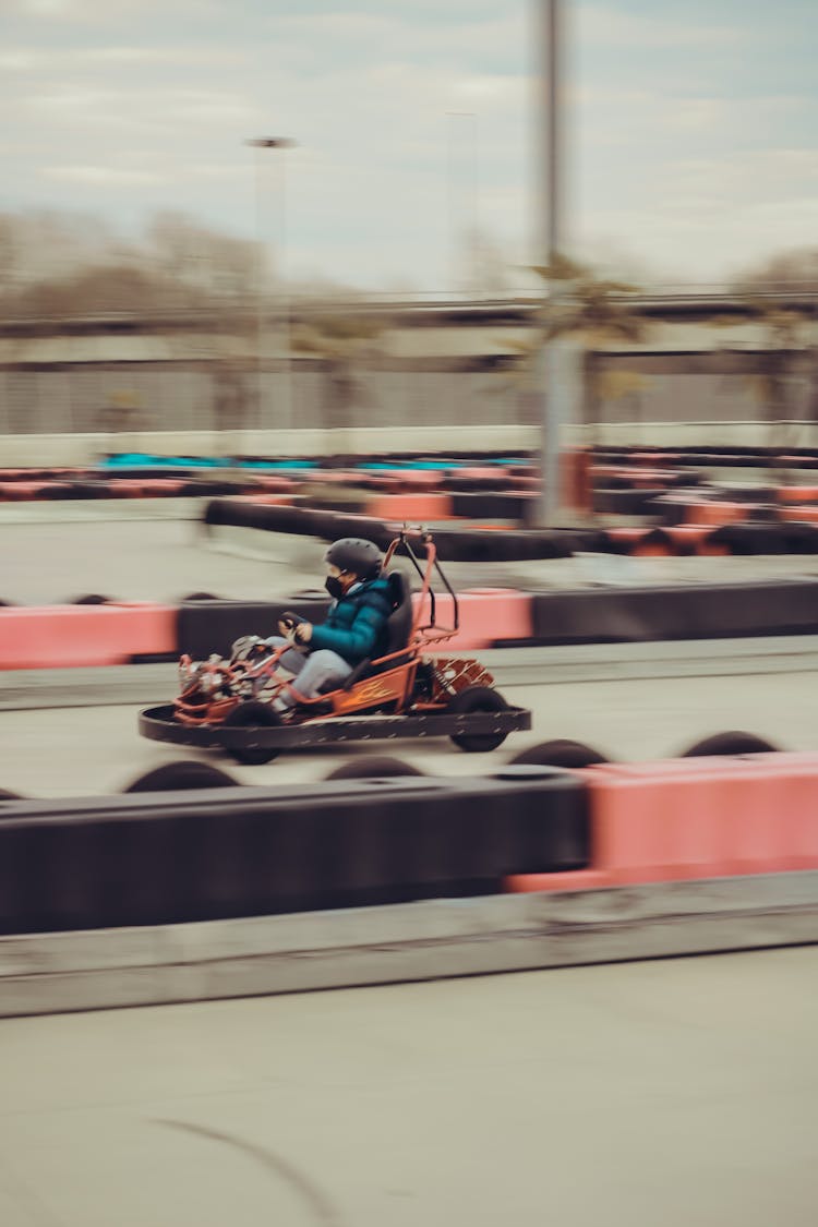 Person Riding A Go Kart On Track