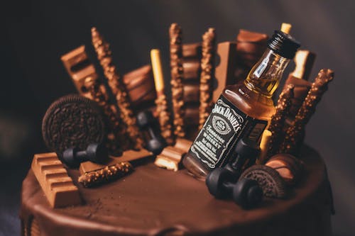 Photo of a Cake with a Bottle of an Alcoholic Drink