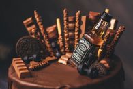 Photo of a Cake with a Bottle of an Alcoholic Drink