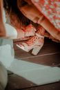 Woman in White and Red Floral Dress Wearing White Leather Peep Toe Heeled Shoes
