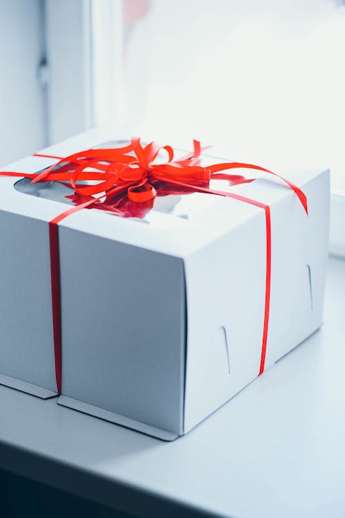 Free Photo of a White Box with a Red Ribbon Stock Photo