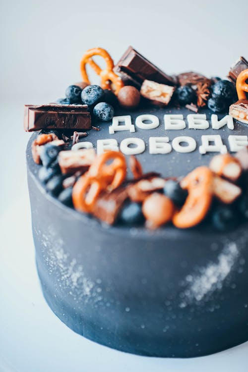 Photo of a Cake with Chocolate Bars and Blueberries