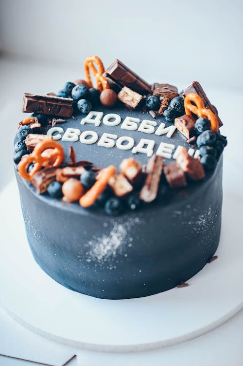 A Black Cake with Pretzels and Blueberries