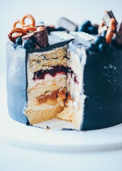 Indulgent multi-layer cake with gourmet toppings, perfect for celebrations.