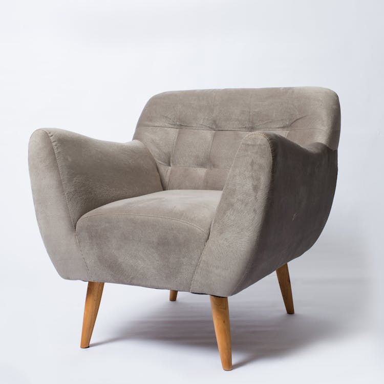 A Soft Cushion Armchair In Gray Upholstery