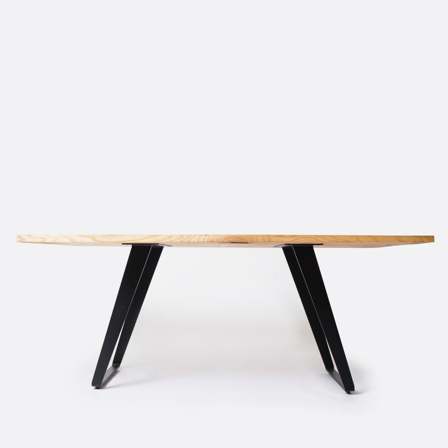 Live-edge wooden dining table on splayed steel legs, studio shot — photo by Ksenia Chernaya on Pexels