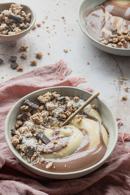 Delicious chocolate and vanilla swirl pudding topped with nuts and crumbled cookies.