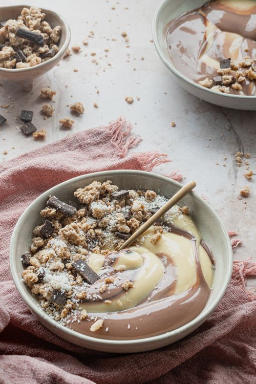 Free Delicious chocolate and vanilla swirl pudding topped with nuts and crumbled cookies. Stock Photo