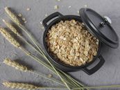 Black Plastic Round Container With Brown Peanuts
