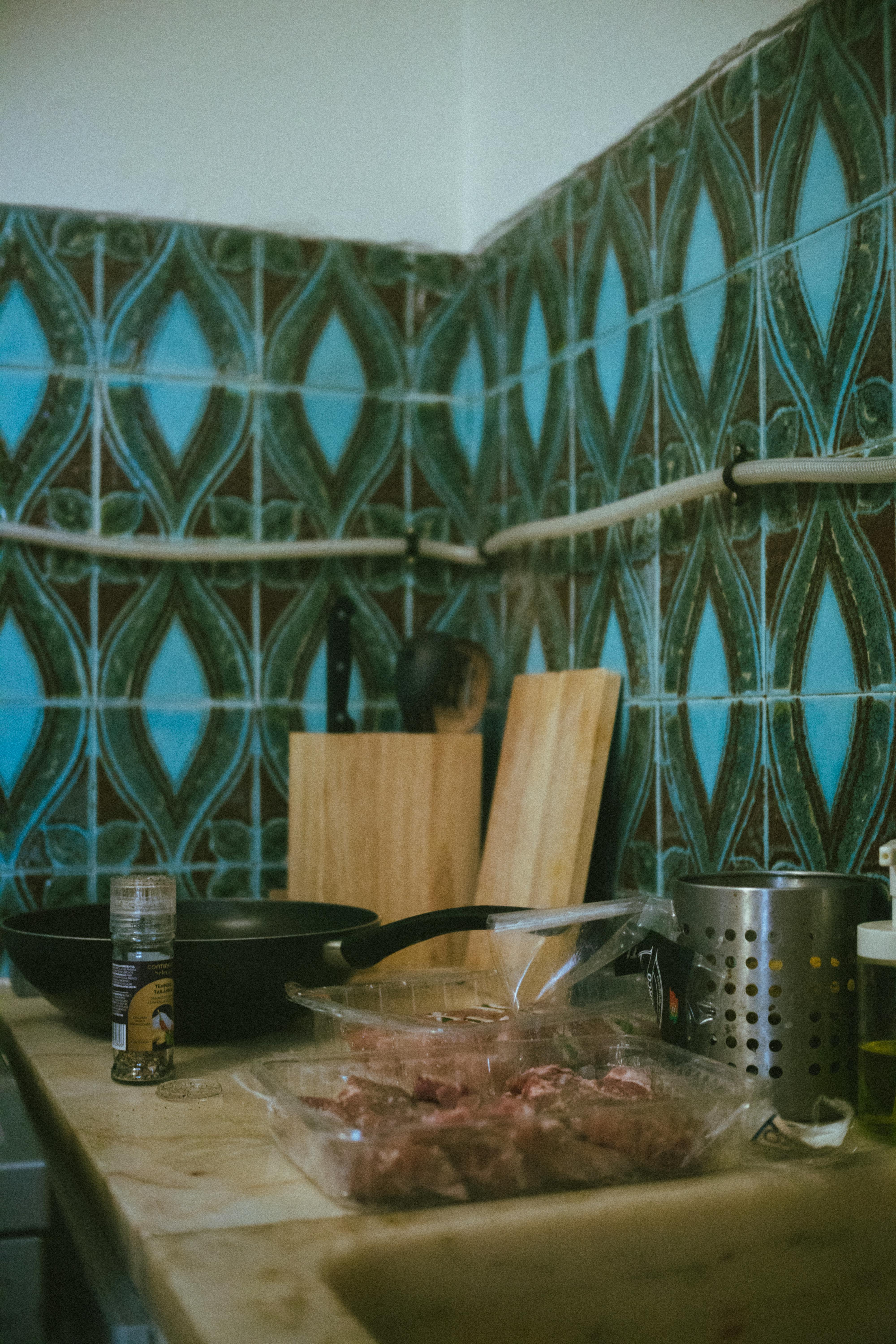 Person preparing lentil curry with spices in a pan
